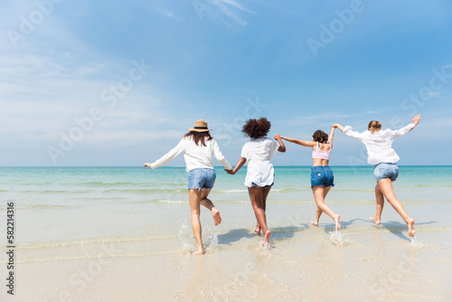 Holiday summer activity, Diverse teenage friends running into the sea. Group of friends playing on the beach. Lifestyles on vacation and holiday, Travel concept.