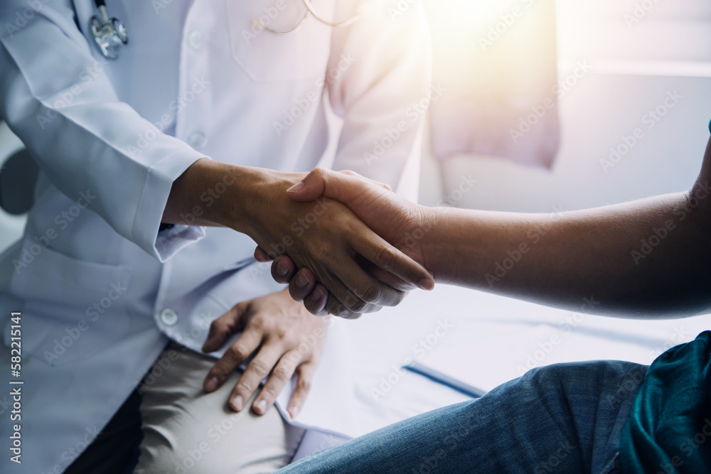 Doctor and patient discussing something while sitting at the table . Medicine and health care concept. Doctor and patient Doctor and patient discussing something while sitting at the table . Medicine and health care concept. Doctor and patient