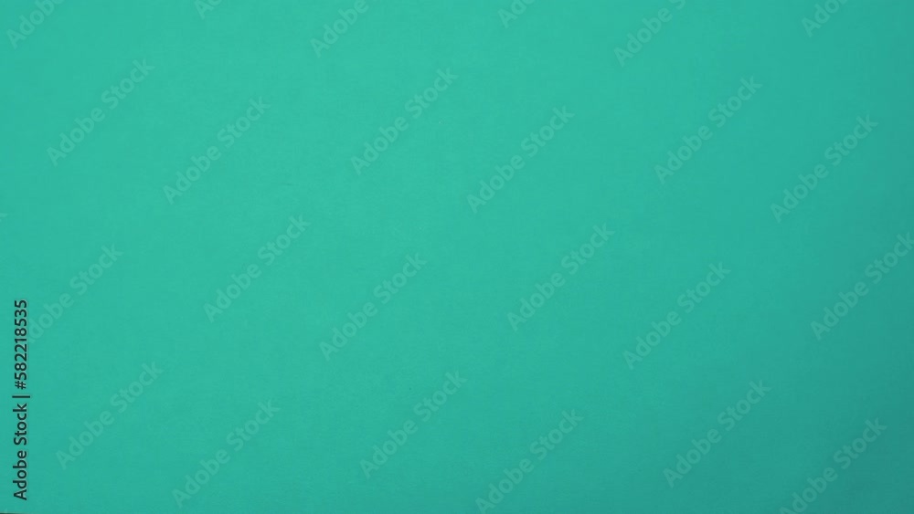 Close-up. A hand against a solid color background passes a sticker, a card with the text Time Management. Close-up. A hand against a solid color background passes a sticker, a card with the text Time Management.