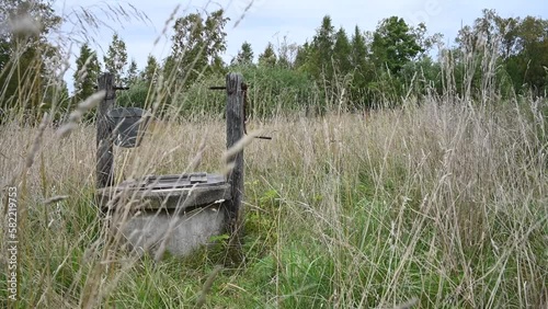 An old abandoned crank well in a summer meadow. Estonia.