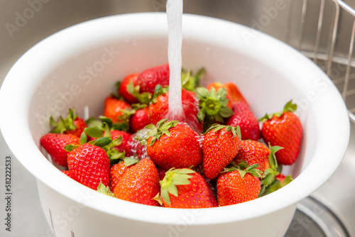 Wash strawberry in kitchen at home