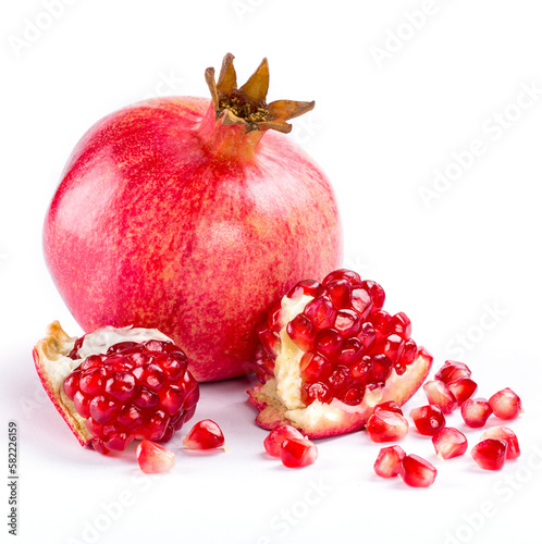 Natural food concept. Side view photo of ripe pomegranate and slices isolated on white background