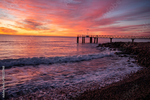 
silhouette of a jetty on the sea at sunrise in the mediterranean sea