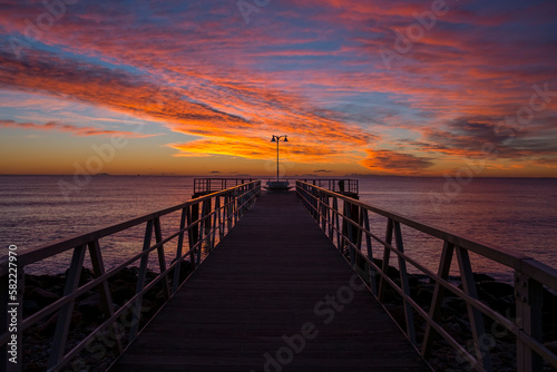 
silhouette of a jetty on the sea at sunrise in the mediterranean sea