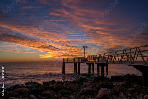 
silhouette of a jetty on the sea at sunrise in the mediterranean sea