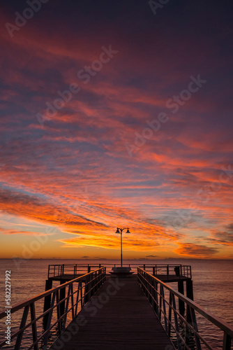 
silhouette of a jetty on the sea at sunrise in the mediterranean sea