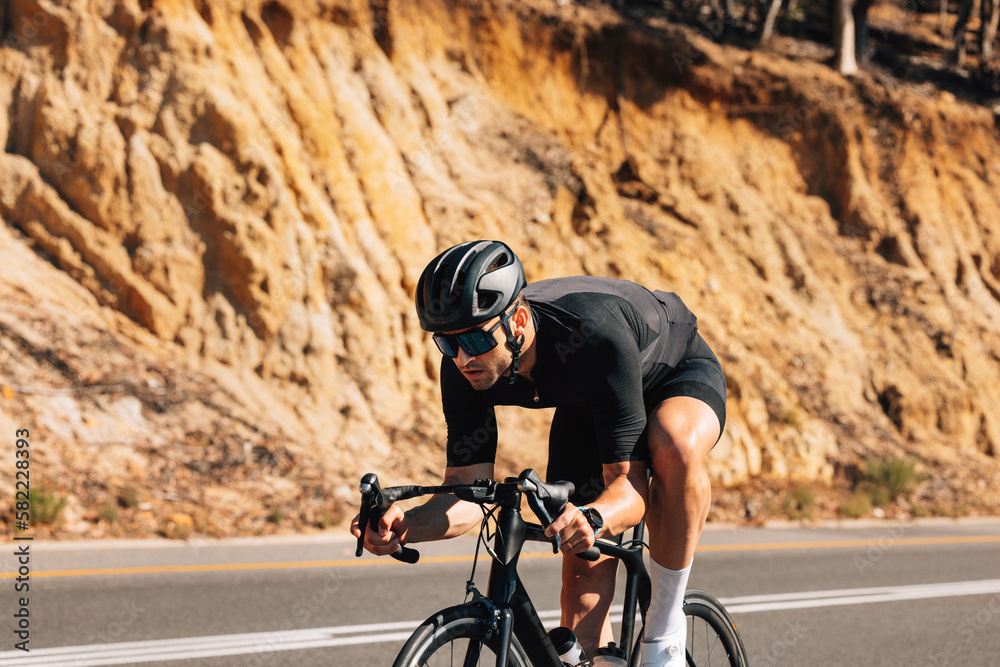 Tough cyclist on his road bike. Professional cyclist in black