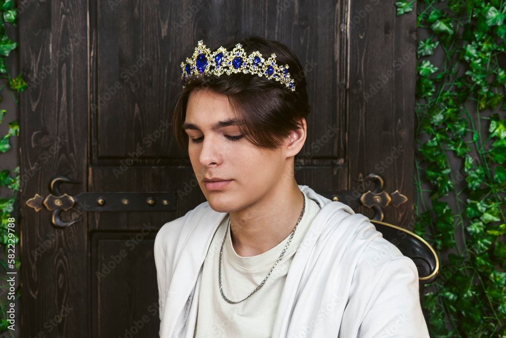 A young fictional nobleman or royal member with a tiara on his head.