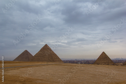 The Great Pyramids of Giza with the hazy city of Cairo behind them.