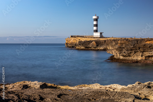 Black and white striped lighthouse of Colonia de Sant Jordi on a rocky headland, Majorca, Mallorca, Balearic Islands, Spain, Europe