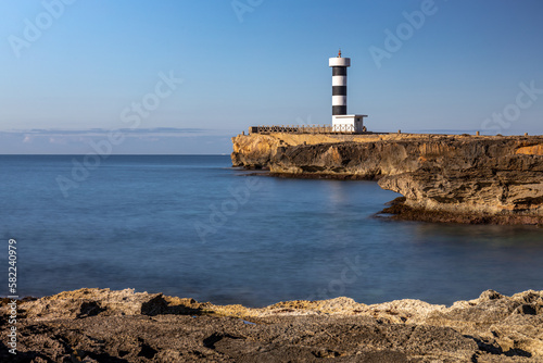 Картината върху платно Black and white striped lighthouse of Colonia de Sant Jordi on a rocky headland,