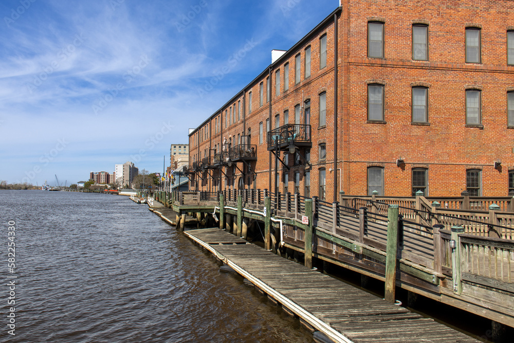 Old Wilmington N.C river. downtown boardwalk with brick building and dock walkway