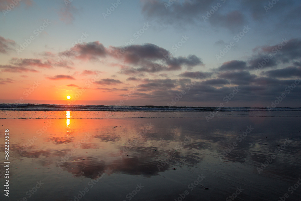 A beautiful and reflective sunset at Blacks Beach in San Diego, California