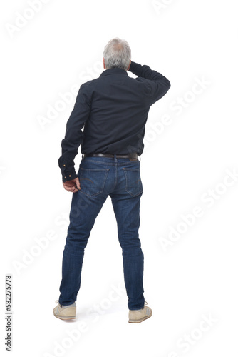 back view of standing man looking away with hand on forehead on white background