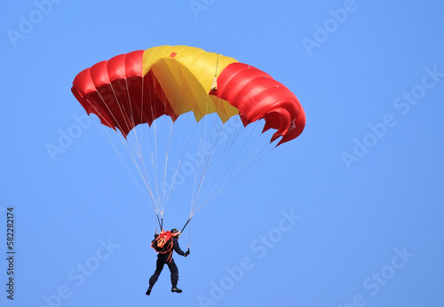 flying with a parachute on a summer day