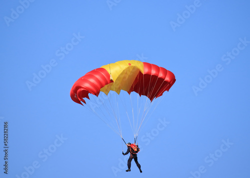 flying with a parachute on a summer day