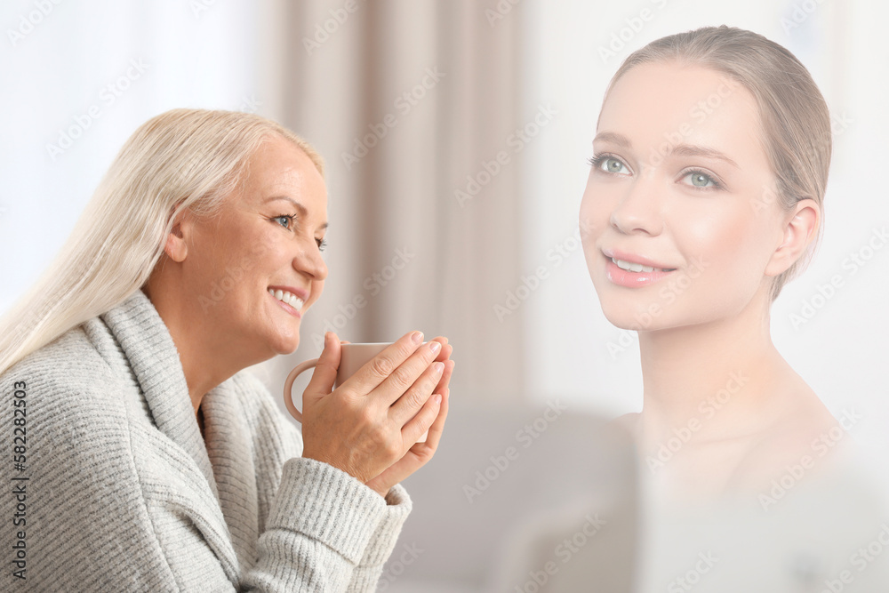 Mature woman remembering old times. Translucent picture of young girl showing her in her youth Mature woman remembering old times. Translucent picture of young girl showing her in her youth