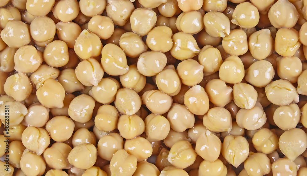 Full frame closeup of many pickled canned yellow chickpeas for seamless background