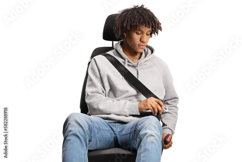 African american young man in a car seat buckling a seatbelt