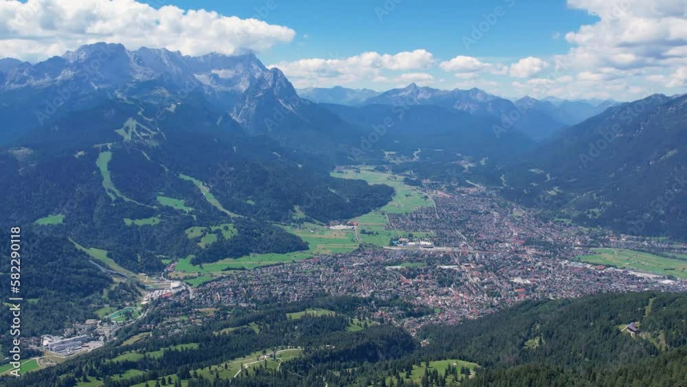 Aerial of Garmisch Partenkirchen Bavarian village in Alps mountains. Summer time, long shot Aerial of Garmisch Partenkirchen Bavarian village in Alps mountains. Summer time, long shot