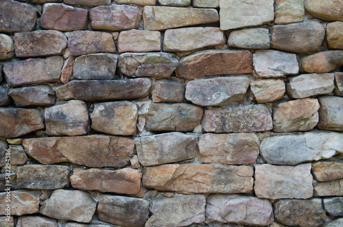 Stone wall for background. Rock wall, Stone wall in outdoor setting, excellent backdrop. Natural rock and stone masonery work. photo