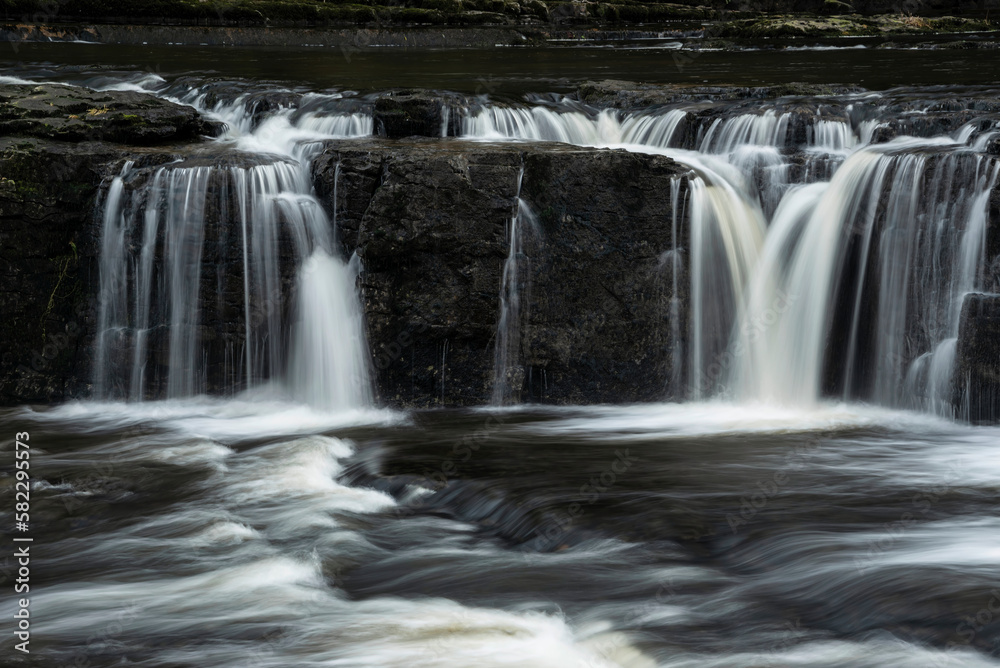 Beautiful dramatic landscape image of Aysgarth Falls in Yorkshire Dales in England during Winter morning