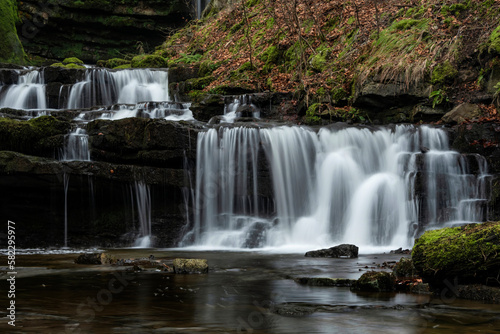 Beautiful peaceful landscape image of Scaleber Force waterfall in Yorkshire Dales in England during Winter morning