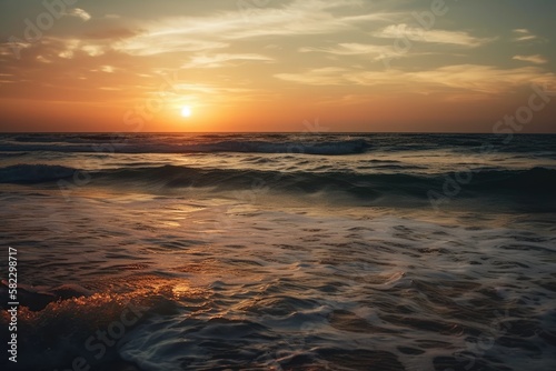 Ocean sea horizon a seascape and a skyscape. Soft sand  a sunset sky that is orange and golden  serenity  peaceful sunlight  and a summertime mood. Beautiful natural scenery with a vast horizon of sky