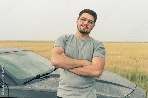 sexy man and black sports car. Handsome guy traveling by his car.  Sportive man. guys love toys