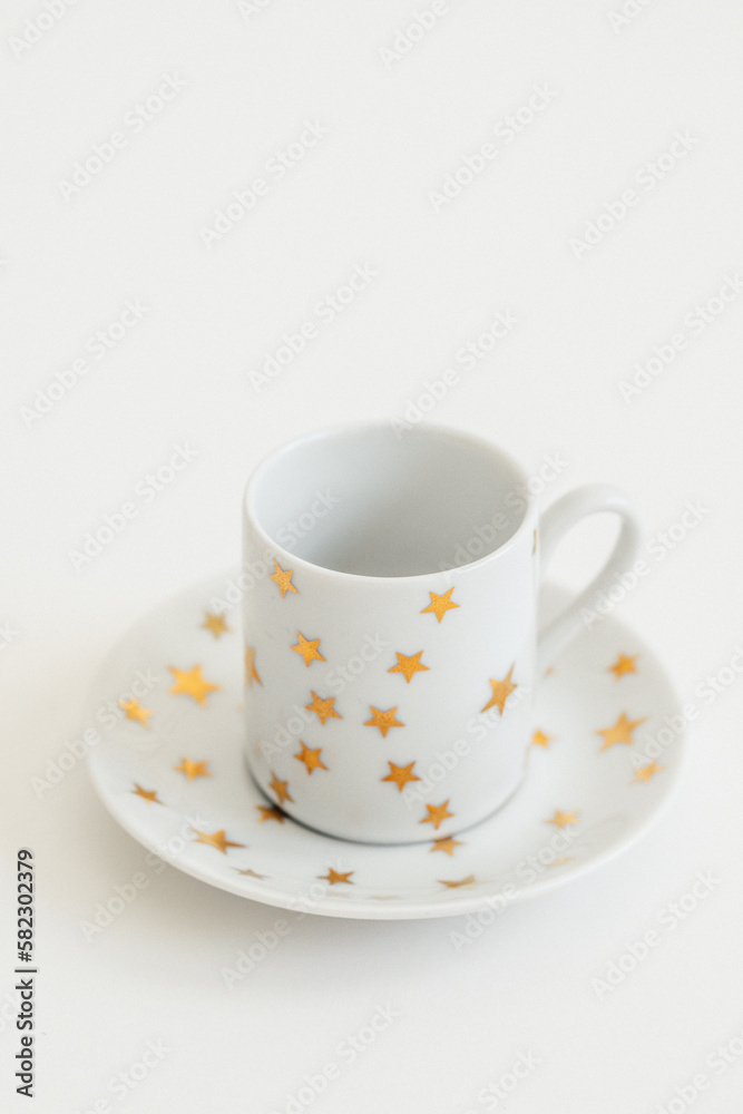white espresso, Turkish coffee cup with gold stars on white background white espresso, Turkish coffee cup with gold stars on white background