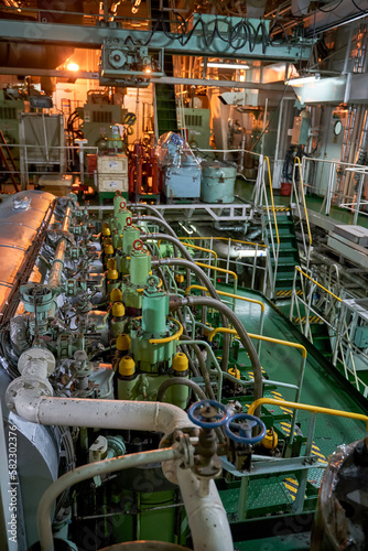 Ship's engine room. Vessel's ( Ship ) Engine Room Space / industrial stairs. Ship's Engine Heavy Machinery Space - Pipes, Valves, Engines