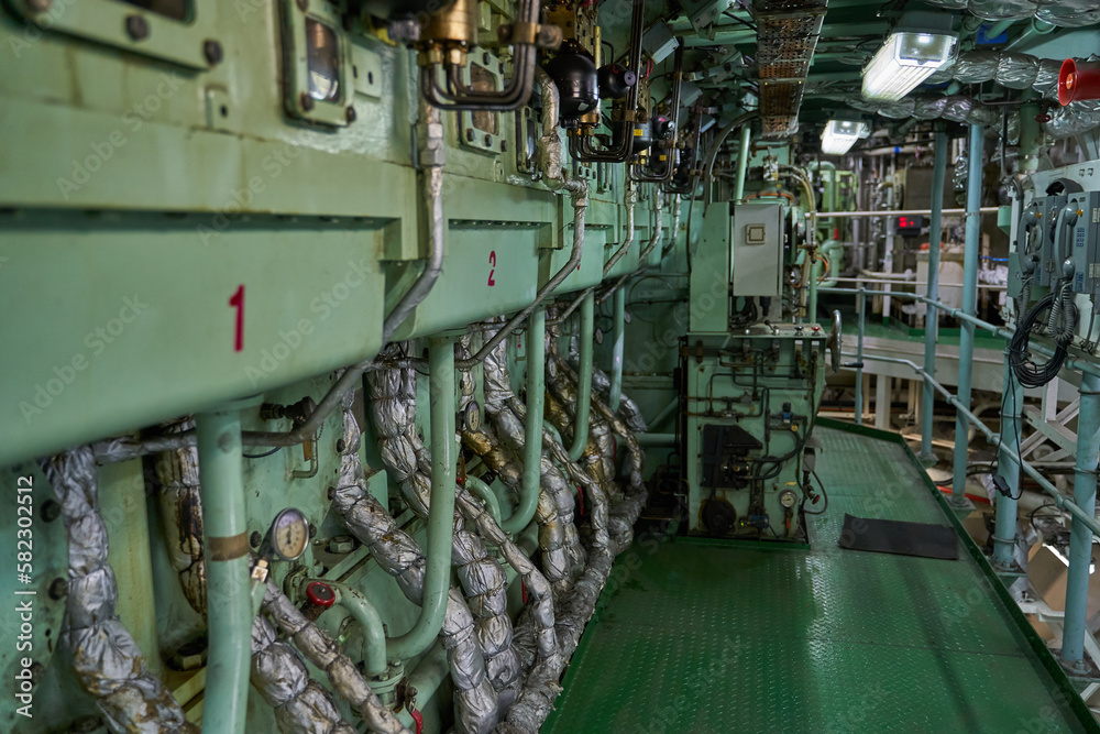 Ship's engine room. Vessel's ( Ship ) Engine Room Space / industrial stairs. Ship's Engine Heavy Machinery Space - Pipes, Valves, Engines