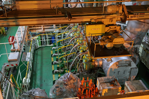 Ship's engine room. Vessel's ( Ship ) Engine Room Space / industrial stairs. Ship's Engine Heavy Machinery Space - Pipes, Valves, Engines