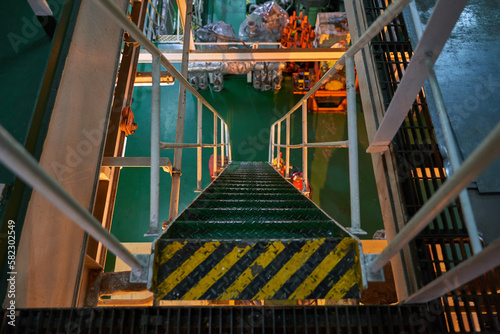 Ship's engine room. Vessel's ( Ship ) Engine Room Space / industrial stairs. Ship's Engine Heavy Machinery Space - Pipes, Valves, Engines