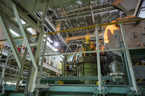 Ship's engine room. Vessel's ( Ship ) Engine Room Space / industrial stairs. Ship's Engine Heavy Machinery Space - Pipes, Valves, Engines