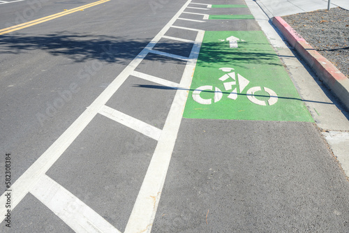 Obraz na płótnie Bicycle lane marked in green along a road in a business park on a sunny day