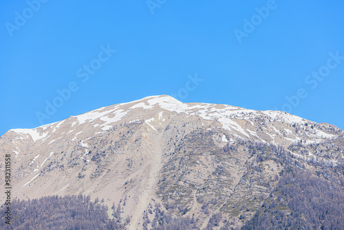 A scenic view of majestic snowy mountain under a majestic blue sky  © Dolwolfian