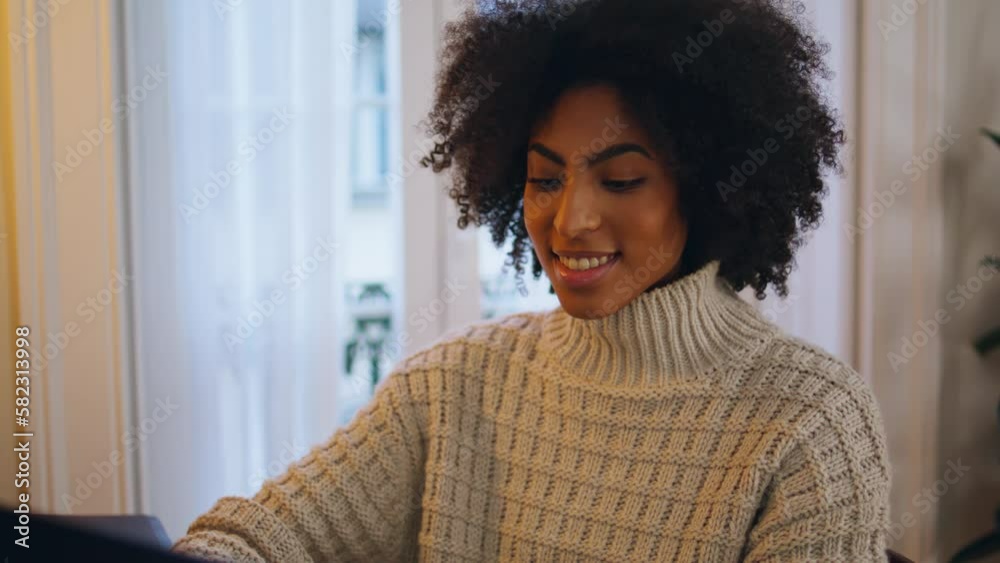 Positive girl chatting computer at home close up. African lady texting message Positive girl chatting computer at home close up. African lady texting message