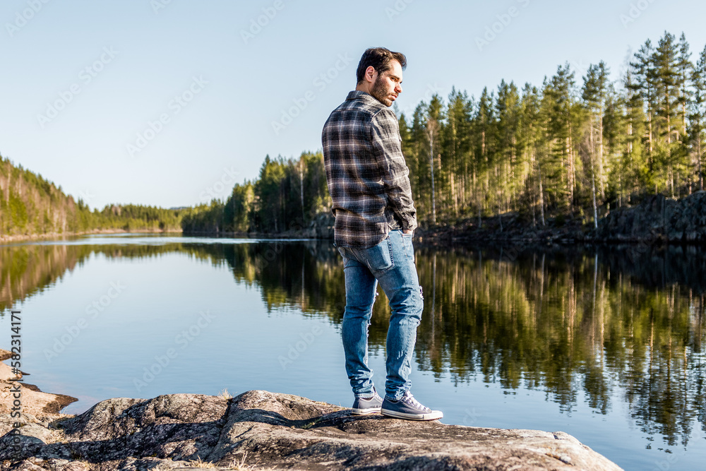 Young man standing by the river