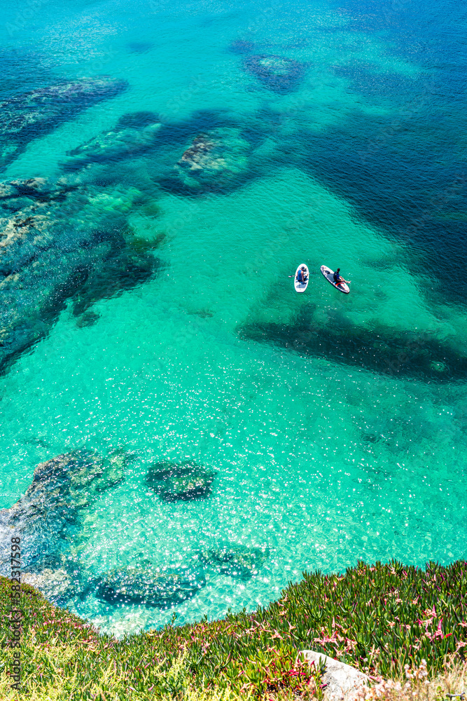Fototapeta premium People on padelboards, Piskies Cove, South West Coast Path, Penzance, Cornwall, England