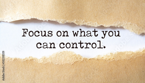 Focus on what you can control. Words written under torn paper. Motivation concept text.