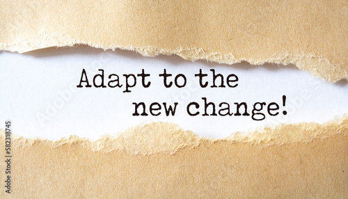 Adapt to the new change. Words written under torn paper.