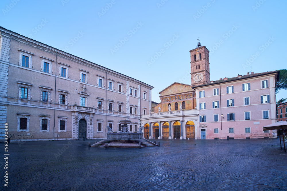 Piazza di Santa Maria in Trastevere, early morning in a square at the heat of Rome, Italy