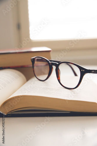 open book with eyeglasses set on it