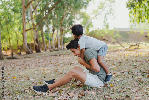 Dad and son play at the park