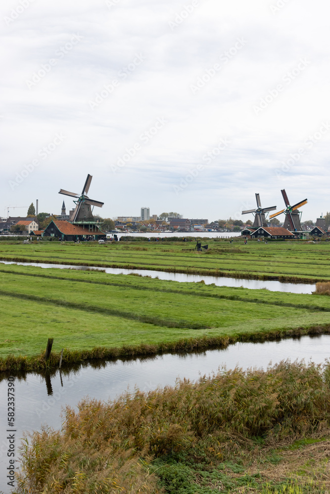 Beautiful Zaanse Schans Windmill Landscape on a Cloudy Autumn Day with a Canal in the Netherlands