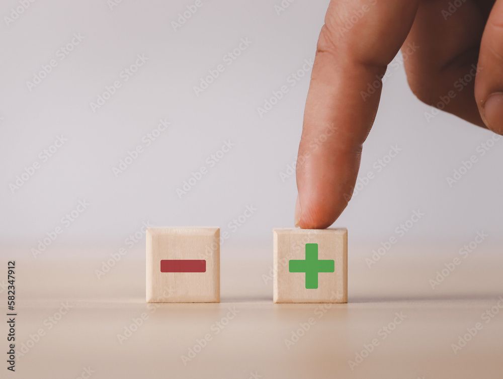 Wooden blocks showing plus and minus signs. The concept of antithesis ...
