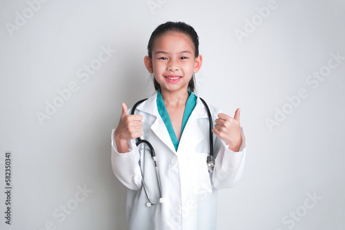 Asian child Wearing a doctor s suit and having a stethoscope