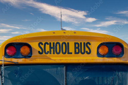 A close up to a yellow SCHOOL BUS sign. Concept: Students transportation.