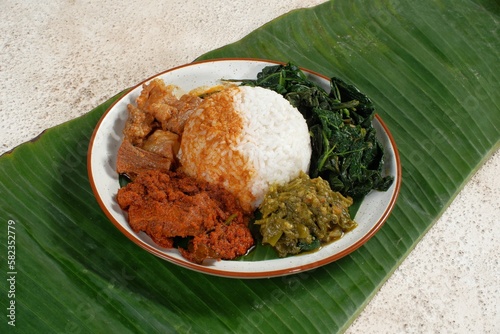 Nasi Padang with rendang is an Indonesian food from West Sumatra in Indonesia. Nasi Padang as favorites food for Indonesian people. photo